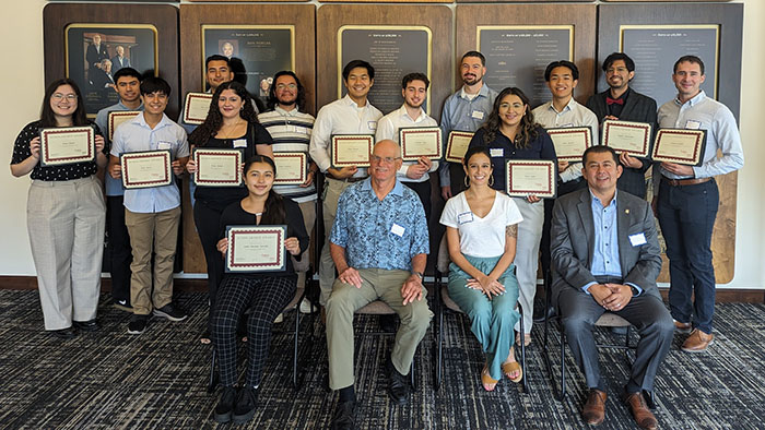 A group of MESA students holding their scholarship certificates