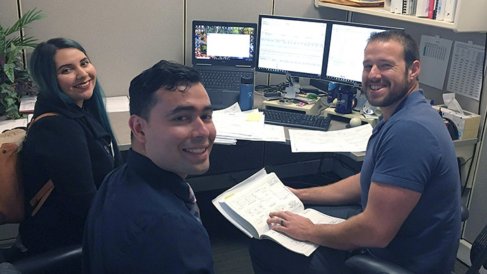 Two MESA students at the desk of an industry volunteer during STEM Shadow Day