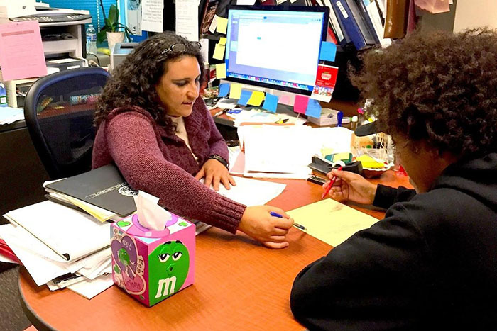 A MESA Academic Advisor at her desk with a student, advising her on which courses to take.