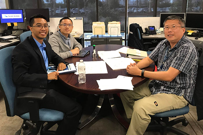 Two MESA students meet with an industry professional at his workplace